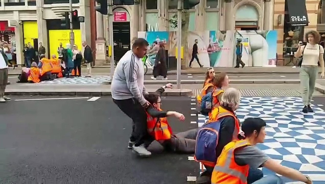 Drivers drag Just Stop Oil protesters off the road. Credit: Just Stop Oil