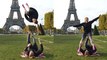 Acrobat helps his partner nail a SICK side flip in front of Eiffel Tower