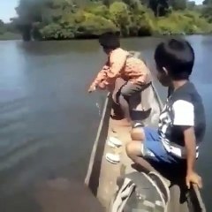 little boy strikes big fish in the river