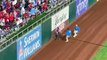 World Series field invader embarrassingly struggles to climb outfield wall as his attempt to escape security FAILS - and his humiliation continues with fans chanting 'a**hole'