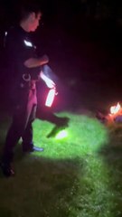 Police officer extinguishing a firework set off in public in Fort Brockhurt, Gosport