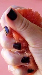A Person Squeezing a Grapefruit