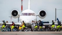 Climate activists ride bikes on runway of Amsterdam airport and block jets from taking off