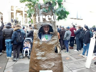 Man dressed as a tree greats King Charles as he arrives in Leeds