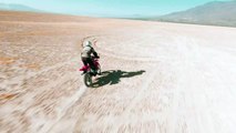 Man crossing the desert on his motorcycle Extreme sports man riding his motorcycle for a motorcycling in the desert on a sunny day.