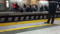 People run for cover as Iranian police appear to open fire on Tehran metro station platform