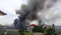 Black smoke rises from fatal car bomb blast outside Thai police compound
