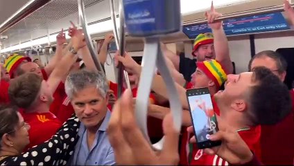 Cymru fans sing the National Anthem on a Doha tram