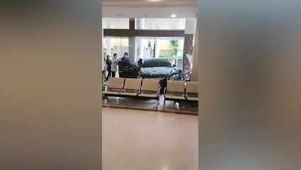 Car covered in glass inside Thai hospital after smashing through entrance