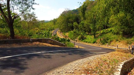 Motorcycle Riders Speeding On A Long And Winding Road