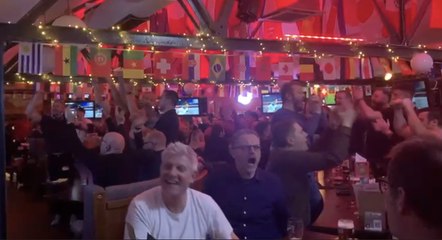 Fans celebrate as England beat Wales in the World Cup to reach the last 16