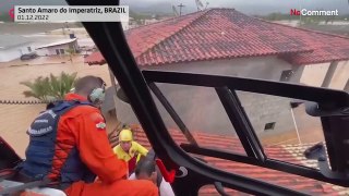 Firefighters rescue stranded people from rooftops in Brazil flooding