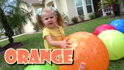 Diana plays with giant inflatable balls