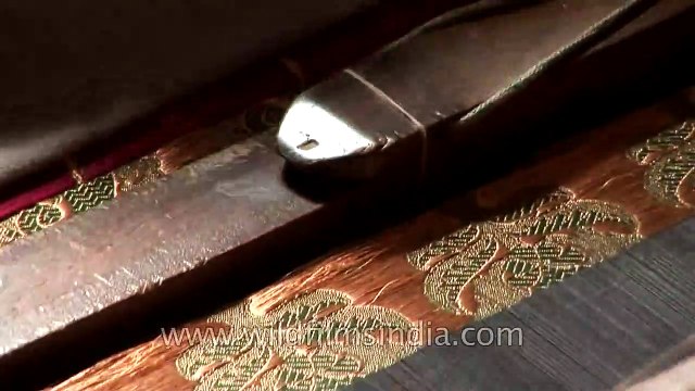 Artisan weaves a Banarasi saree using a traditional weaving machine