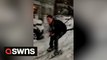 London local hilariously swaps the slopes for the streets - by skiing down a residential road in snow-covered capital