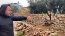 Şiddetli yağan yağmur suyunu tahliye etmek için bahçe duvarını yıktı