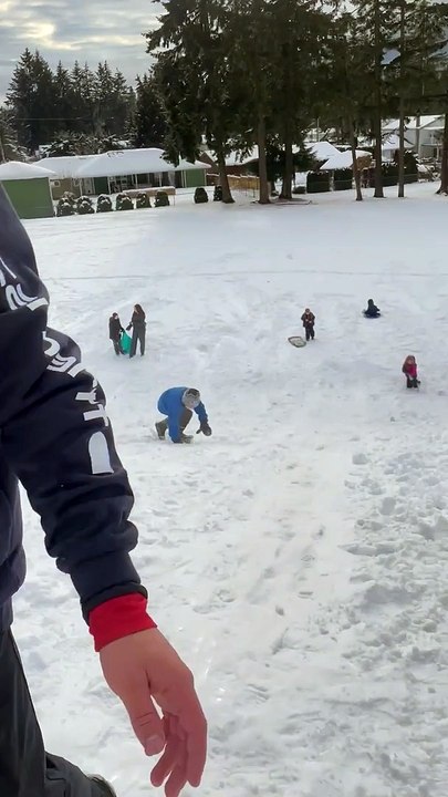 Catching Air Sledding Down a Snowy Slope