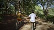 Sepasang - laki - laki - waaita - lagi - naik - sepeda - dihutan -mixkit-couple-of-cyclists-riding-through-nature-together-44341-medium