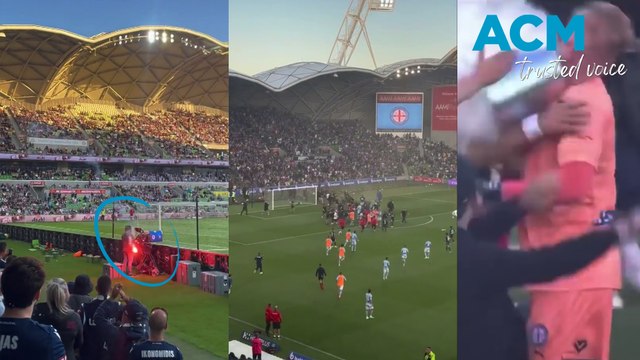 Crowd footage of soccer fans storming the pitch at the Melbourne derby