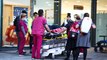 Nurses break a picket line to help an injured man