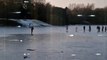 Shocking footage shows a group of ten people sliding and skating on a frozen lake - just days after four boys died after falling into through ice