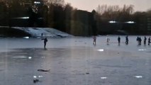 Shocking footage shows a group of ten people sliding and skating on a frozen lake - just days after four boys died after falling into through ice