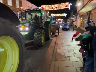 Watch as a Christmas procession of decorated tractors passes through Petersfield