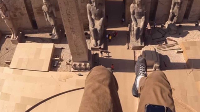 Paramotor pilot glides over the ancient Luxor Temple in Egypt *AWE-STRIKING*