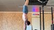 Personal Trainer Performs Handstand Pushups at the Gym
