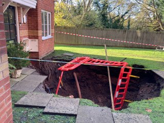 Dad tells how he cheated death by "three seconds" after a 70ft sinkhole appeared in front of his home