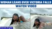 Viral Video: Woman leans over the edge of 360-ft-tall Victoria Falls | Oneindia News *International