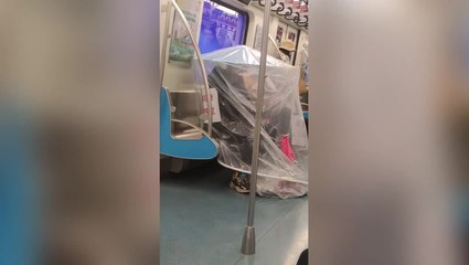 China subway passenger wears DIY full-body mask as Covid cases surge