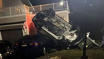 Stolen car flips off embankment and lands on house in New Jersey