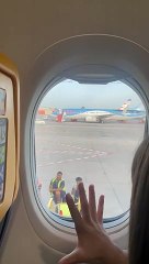 Girl Plays Rock Paper Scissors from Airplane Window