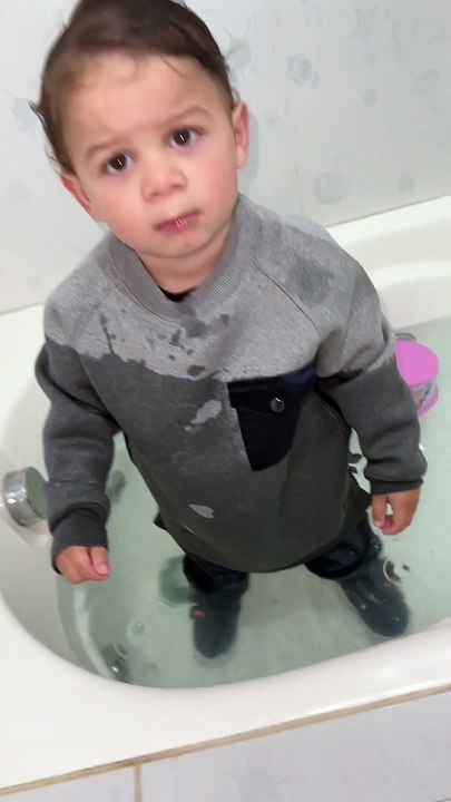 Toddler Climbs into Bathwater Fully Clothed
