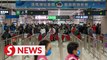 Thousands cross Hong Kong-mainland border as China ends quarantine for inbound travellers