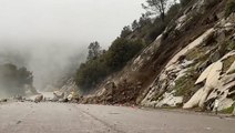 Moment landslide blocks flooded road amid California storm