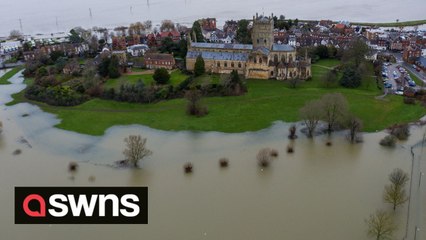 Tewkesbury Abbey turned into an island as flood water streams off the Malverns