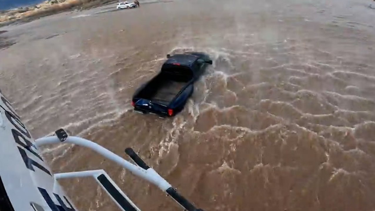 Driver rescued from submerged car by helicopter after ignoring Arizona flood warnings