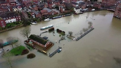 Parts of a town almost completely cut off by floods after heavy downpours batter Britain