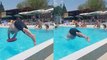 Fun-loving adult tries diving through a tube floating in pool