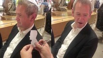 Expert paper artist cuts a silhouette of Alexander Armstrong and gifts it to him
