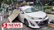 Car on Jalan Ampang damaged by falling construction material
