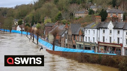 Roads and pathways swallowed by water as flooding caused by heavy rain left Britain's longest river bursting its banks