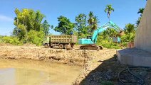 Shantui SD 16 E Bulldozer Overcomes Piles of Sand Transported by Trucks