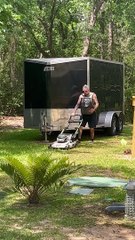 Man Mows Lawn While Carrying Cat in Backpack