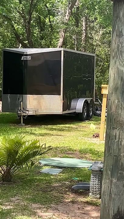Man Mows Lawn While Carrying Cat in Backpack