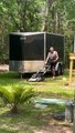 Man Mows Lawn While Carrying Cat in Backpack