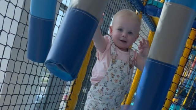Adorable toddler runs face-first into a mirror at the play area for children