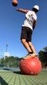 Guy Balancing Himself on Stability Ball Makes Basketball Trickshots